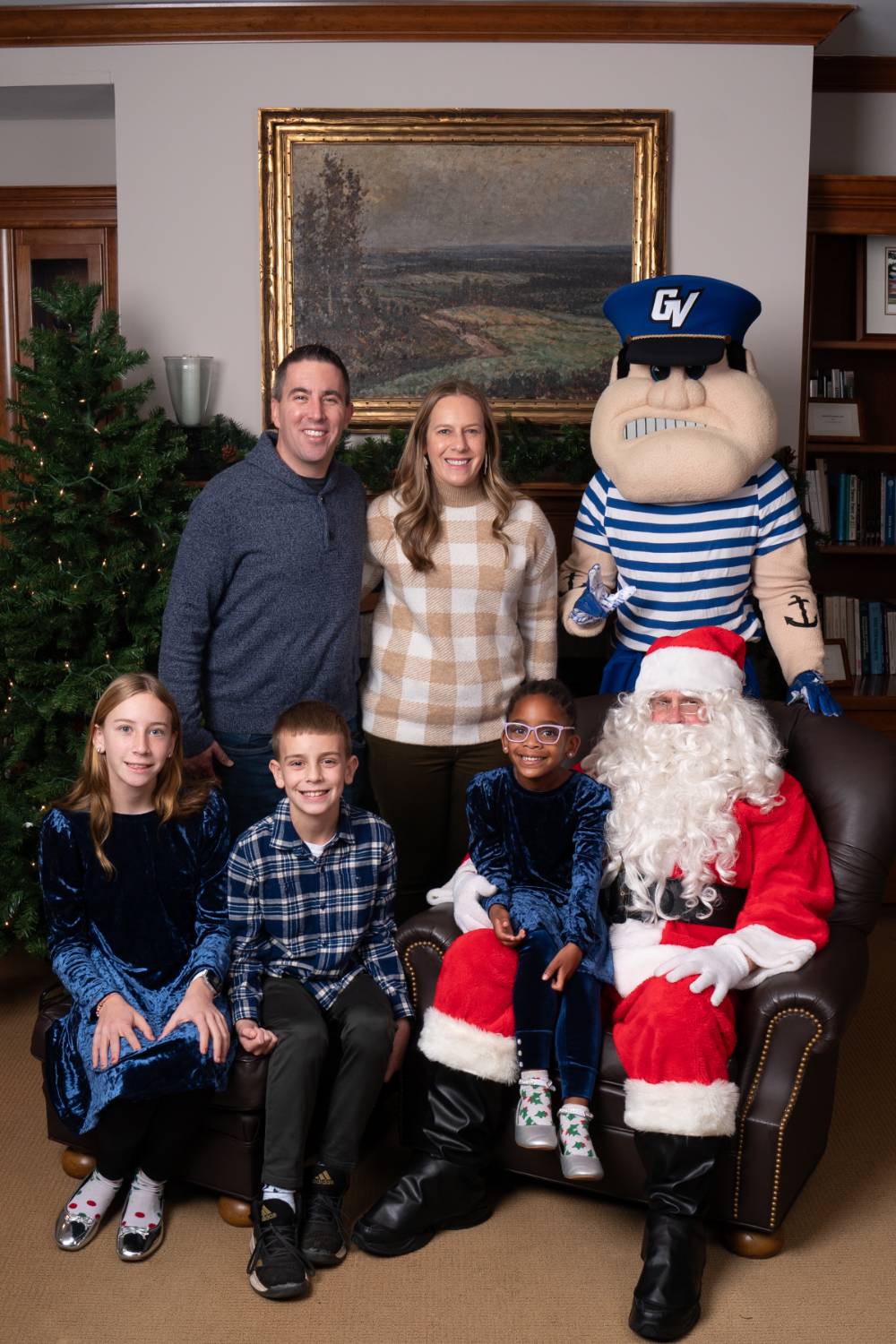 Family of five with Santa and Louie the Laker.